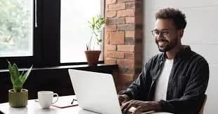 Freelancer working happily on a laptop